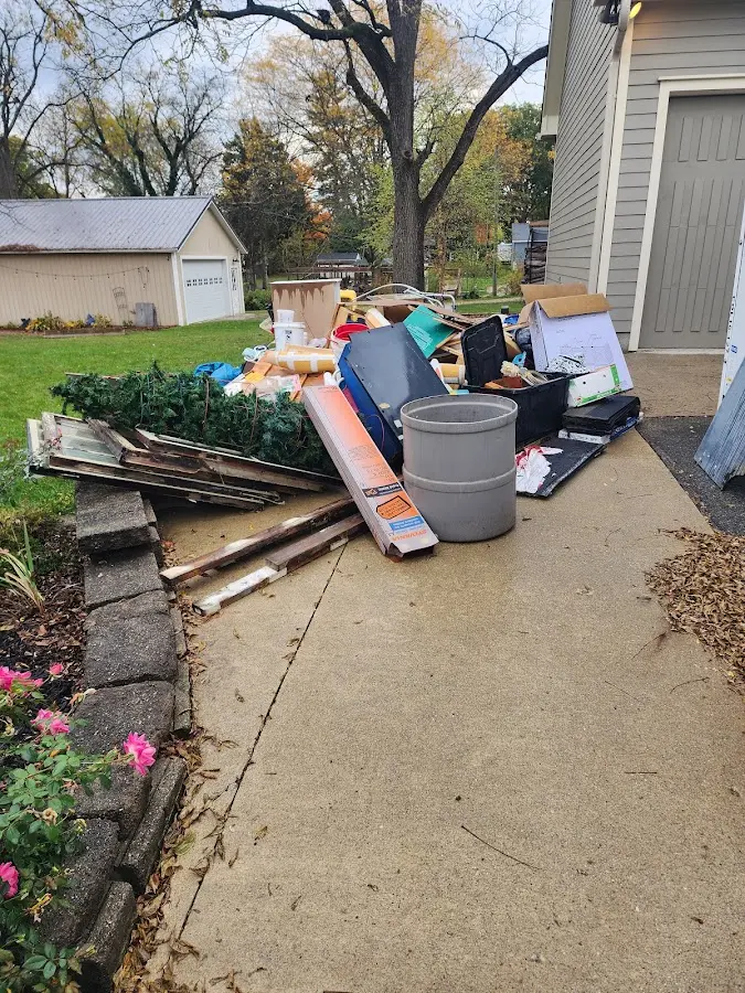 Dumpster being loaded with debris for Roofing Dumpster Rental in St. James
